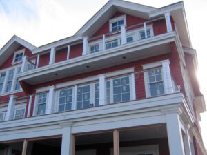 a house with red exterior and three stories