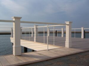 a dock with white cable railings